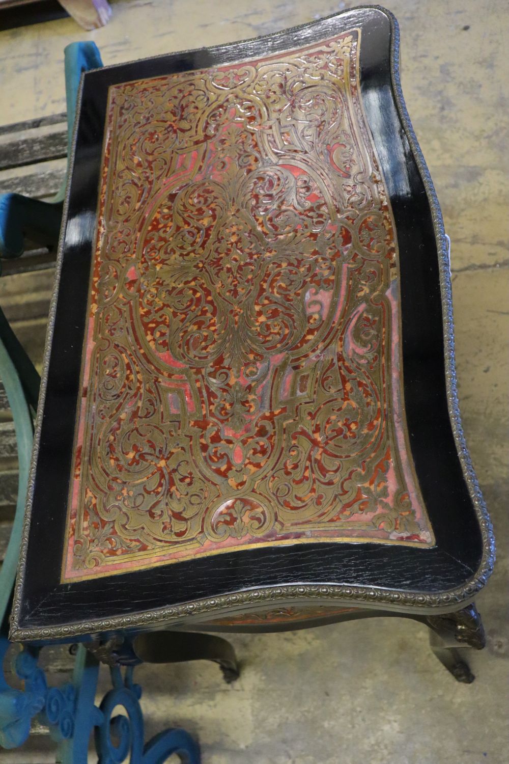 A 19th century French red boullework and ebony card table, with serpentine top, width 74cm